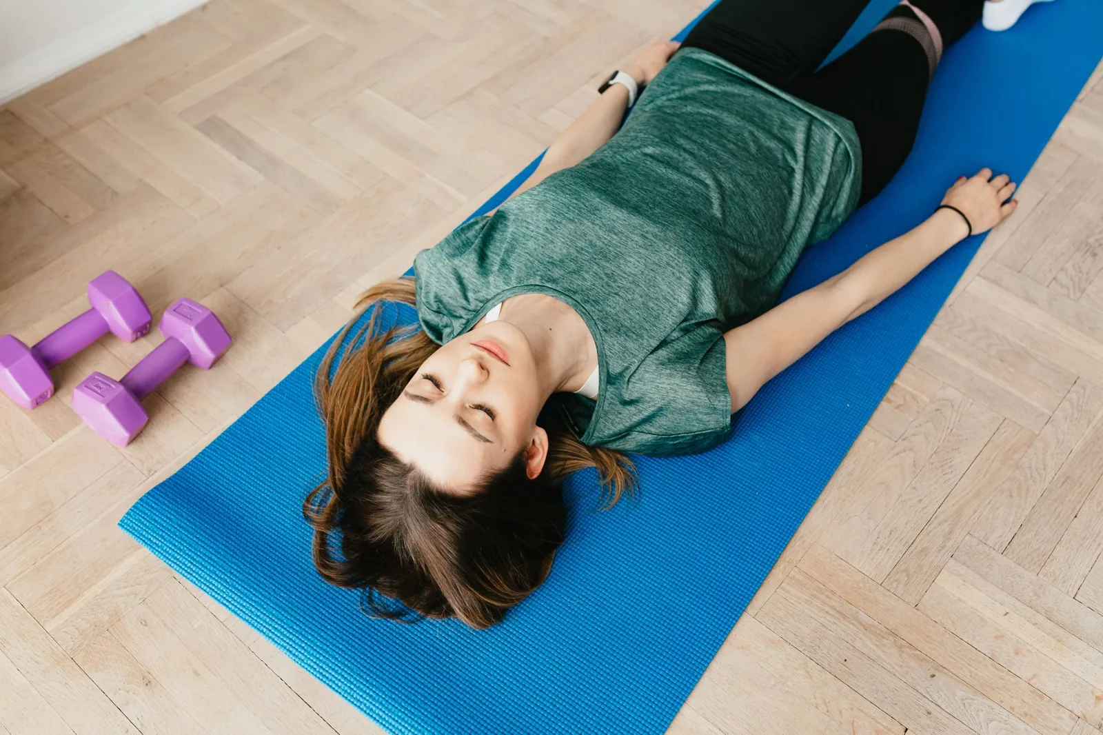 woman meditating lying on a mat — how to meditate in a comfortable posture